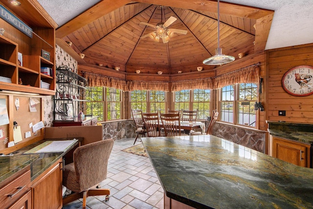 14965 Loon Lake Dr, Bellevue, MI 49021 - dining room featuring wood ceiling, a ceiling fan, wood walls, and high vaulted ceiling