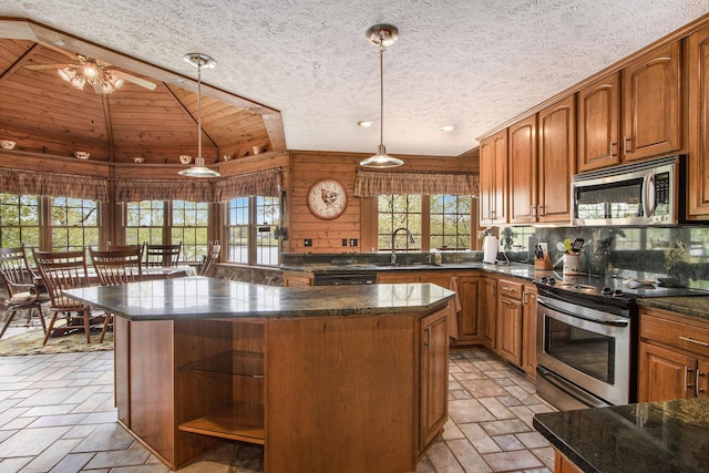 14965 Loon Lake Dr, Bellevue, MI 49021 - kitchen featuring stainless steel appliances, open shelves, vaulted ceiling, a center island, and a sink