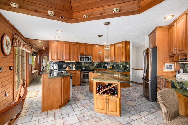 14965 Loon Lake Dr, Bellevue, MI 49021 - kitchen featuring appliances with stainless steel finishes, a sink, brown cabinetry, a center island, and decorative backsplash