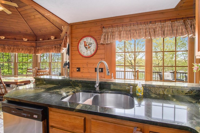 14965 Loon Lake Dr, Bellevue, MI 49021 - kitchen with dishwasher, a sink, lofted ceiling, wood walls, and brown cabinets