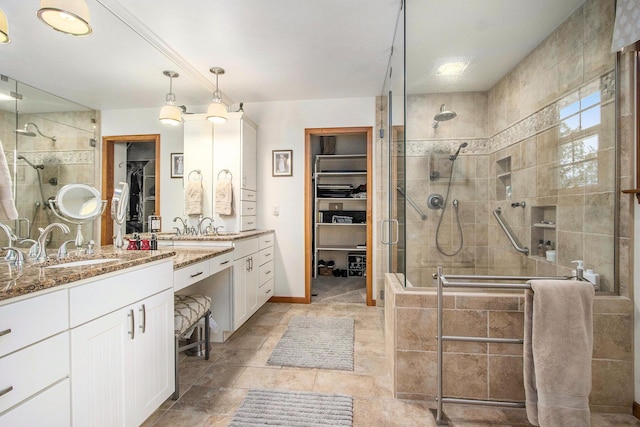 14965 Loon Lake Dr, Bellevue, MI 49021 - bathroom featuring a stall shower, a spacious closet, vanity, and baseboards