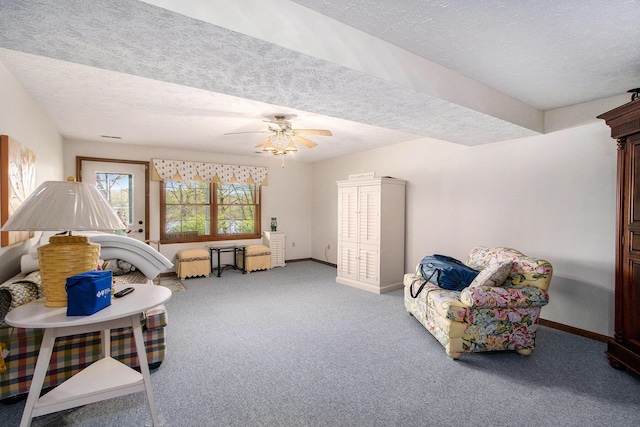 14965 Loon Lake Dr, Bellevue, MI 49021 - living area with carpet flooring, a textured ceiling, a ceiling fan, and baseboards