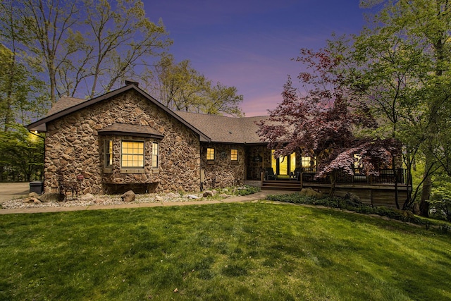 14965 Loon Lake Dr, Bellevue, MI 49021 - view of front of house with stone siding, a yard, and a chimney