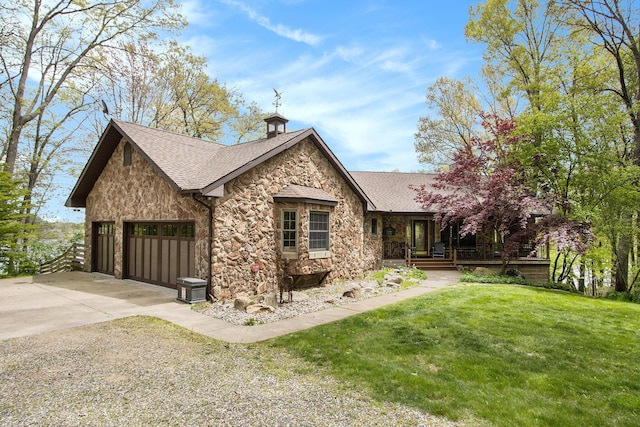 14965 Loon Lake Dr, Bellevue, MI 49021 - view of property exterior featuring stone siding, driveway, an attached garage, a yard, and roof with shingles
