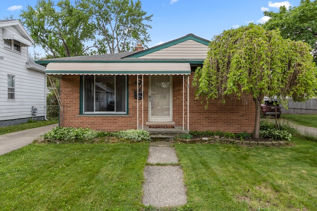 view of front of home featuring brick siding and a chimney