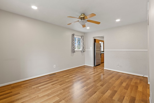 empty room featuring a ceiling fan, recessed lighting, baseboards, and light wood-style floors