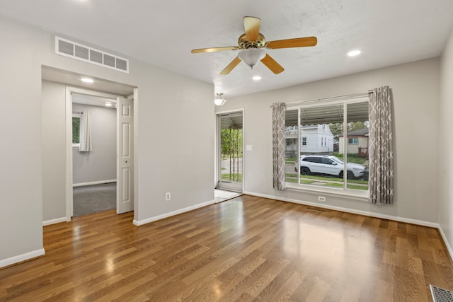 unfurnished room featuring wood finished floors, baseboards, ceiling fan, and recessed lighting