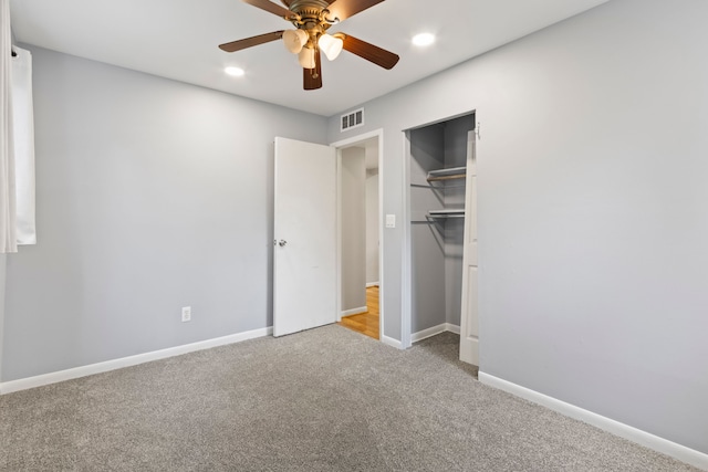unfurnished bedroom featuring carpet, recessed lighting, baseboards, ceiling fan, and a closet