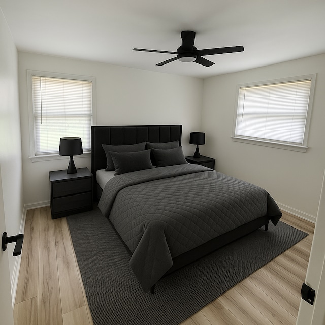 9988 Stout St, Detroit, MI 48228 - bedroom with multiple windows, light wood finished floors, a ceiling fan, and baseboards