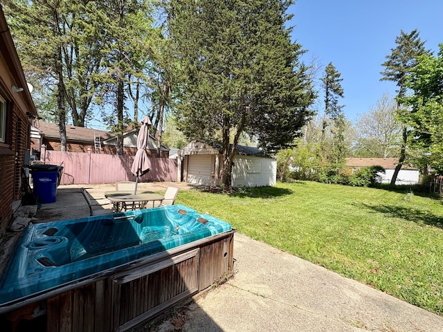 9988 Stout St, Detroit, MI 48228 - view of yard with a hot tub, a patio area, and an outbuilding