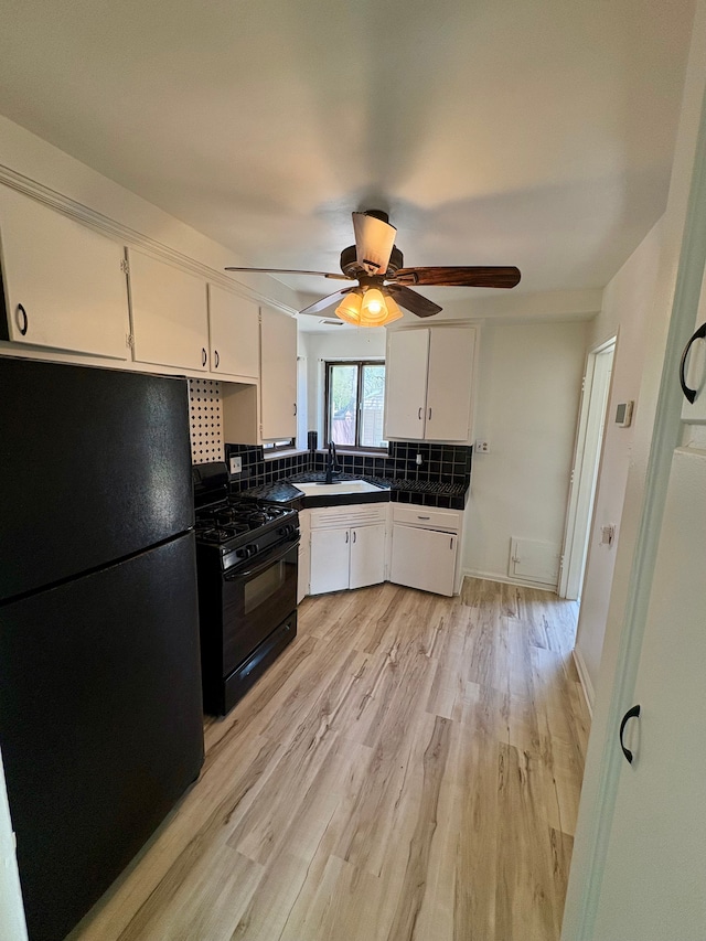 9988 Stout St, Detroit, MI 48228 - kitchen with black appliances, white cabinetry, tasteful backsplash, and ceiling fan