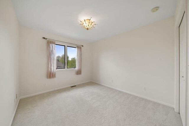 1287 Deer Run, Grass Lake, MI 49240 - empty room with light colored carpet, baseboards, and a smoke detector