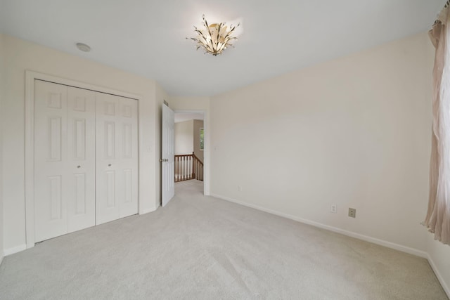 1287 Deer Run, Grass Lake, MI 49240 - unfurnished bedroom featuring light carpet, baseboards, and a closet