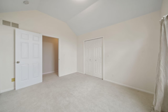 1287 Deer Run, Grass Lake, MI 49240 - unfurnished bedroom featuring lofted ceiling, light carpet, a closet, and baseboards