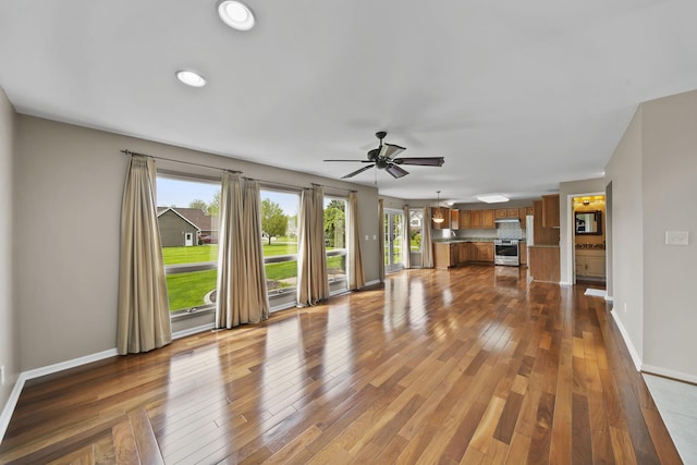 1287 Deer Run, Grass Lake, MI 49240 - unfurnished living room featuring ceiling fan, wood finished floors, baseboards, and recessed lighting