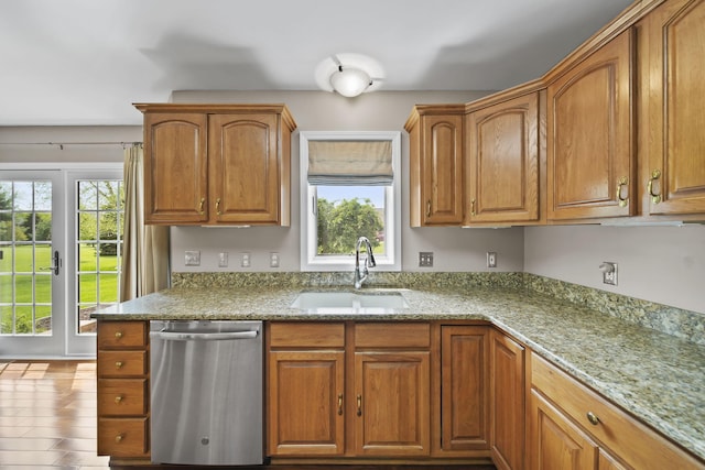 1287 Deer Run, Grass Lake, MI 49240 - kitchen featuring stainless steel dishwasher, a sink, light stone counters, and brown cabinets
