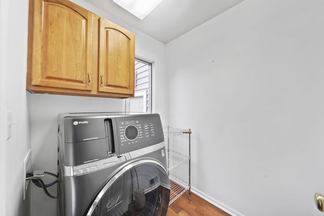 1287 Deer Run, Grass Lake, MI 49240 - laundry room with washer / clothes dryer, cabinet space, baseboards, and wood finished floors