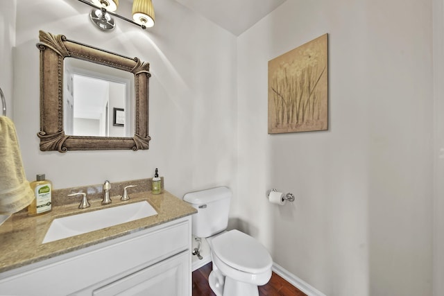1287 Deer Run, Grass Lake, MI 49240 - bathroom with toilet, baseboards, vanity, and wood finished floors