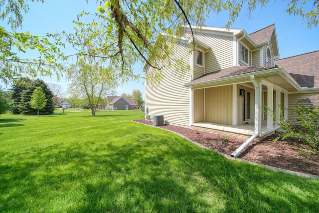 1287 Deer Run, Grass Lake, MI 49240 - view of side of property featuring a yard, central AC unit, a shingled roof, and covered porch