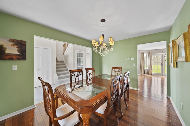 1287 Deer Run, Grass Lake, MI 49240 - dining room featuring stairs, a chandelier, baseboards, and wood-type flooring