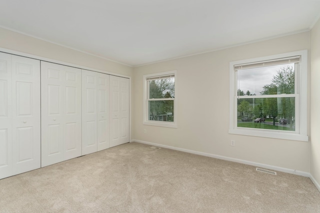 1141 Marquette Ct, Rochester Hills, MI 48307 - unfurnished bedroom featuring carpet, crown molding, baseboards, and a closet
