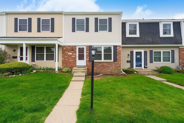 1141 Marquette Ct, Rochester Hills, MI 48307 - view of property with brick siding, a front lawn, and roof with shingles