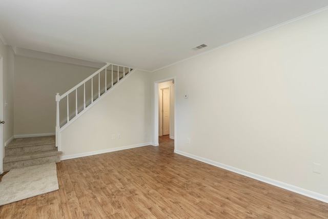 1141 Marquette Ct, Rochester Hills, MI 48307 - unfurnished living room with stairs, light wood finished floors, baseboards, and ornamental molding
