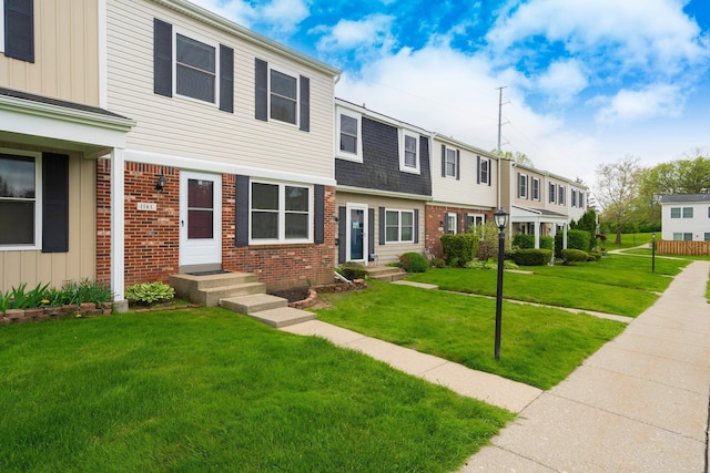 1141 Marquette Ct, Rochester Hills, MI 48307 - townhome / multi-family property with brick siding, a front lawn, and board and batten siding