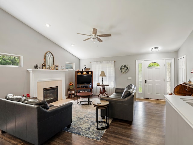 living room with a ceiling fan, dark wood-style flooring, a tile fireplace, lofted ceiling, and recessed lighting