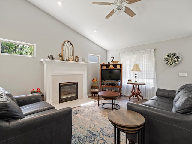 living room featuring a ceiling fan, lofted ceiling, a fireplace, and recessed lighting