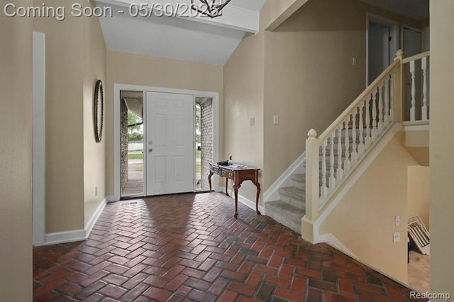 29290 Prestwick St, Southfield, MI 48076 - foyer entrance featuring baseboards, stairway, brick flooring, and lofted ceiling