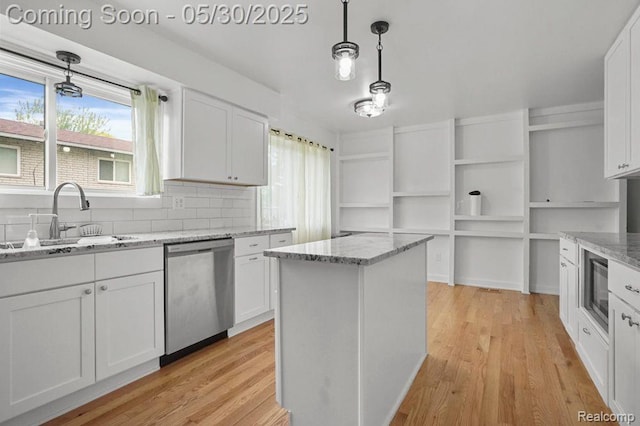 29290 Prestwick St, Southfield, MI 48076 - kitchen featuring stainless steel dishwasher, a sink, white cabinetry, and light wood-style floors