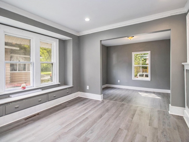 empty room with ornamental molding, baseboards, wood finished floors, and recessed lighting