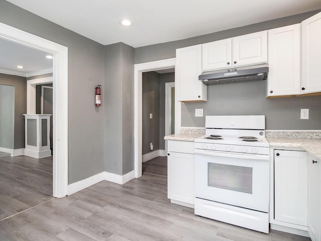 kitchen with white range with electric cooktop, under cabinet range hood, light countertops, white cabinetry, and baseboards