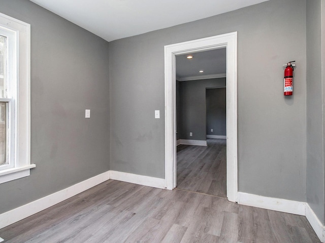 unfurnished room with baseboards and wood finished floors