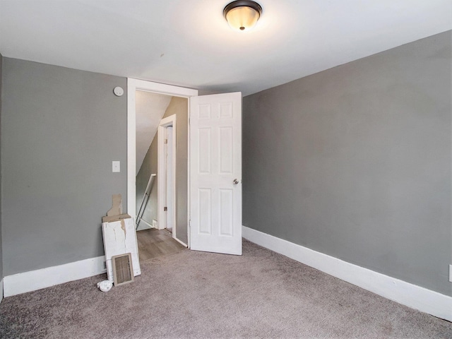 unfurnished bedroom featuring carpet and baseboards