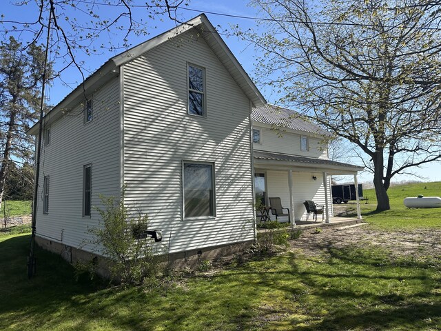 5342 E Fountain Rd, Fountain, MI 49410 - view of side of property featuring a yard, covered porch, crawl space, and a metal roof