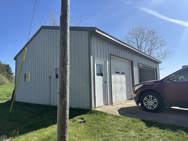 5342 E Fountain Rd, Fountain, MI 49410 - view of property exterior featuring board and batten siding, an outdoor structure, a yard, and a detached garage