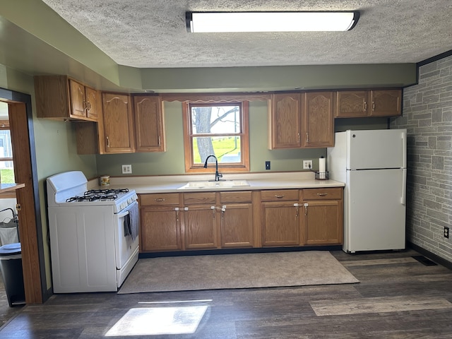 5342 E Fountain Rd, Fountain, MI 49410 - kitchen featuring white appliances, dark wood-style floors, light countertops, a textured ceiling, and brown cabinetry