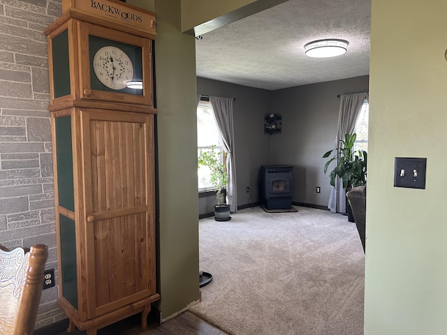 5342 E Fountain Rd, Fountain, MI 49410 - carpeted living room with a wood stove and a textured ceiling