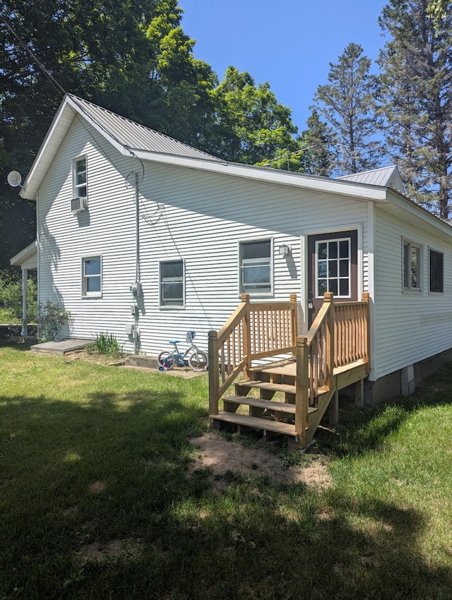 5342 E Fountain Rd, Fountain, MI 49410 - rear view of property with a lawn, a metal roof, and a deck