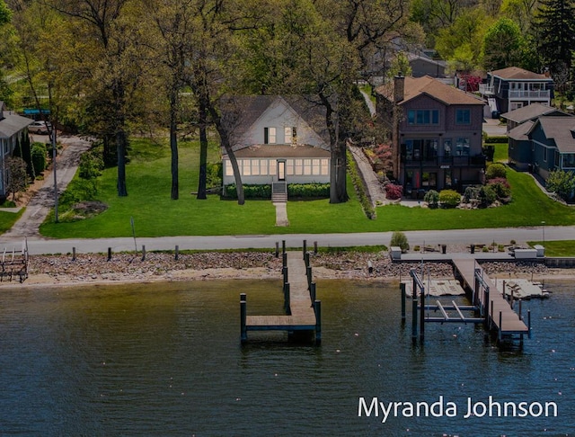 15926 Beach Dr, Spring Lake, MI 49456 - dock area featuring a water view, a lawn, and boat lift
