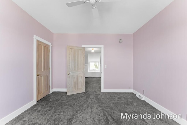 15926 Beach Dr, Spring Lake, MI 49456 - unfurnished bedroom featuring dark colored carpet, baseboards, and a ceiling fan