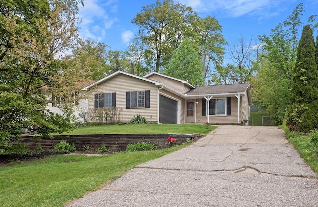 3884 Cass Elizabeth Rd, Waterford, MI 48328 - view of front of home featuring a garage, driveway, and a front lawn