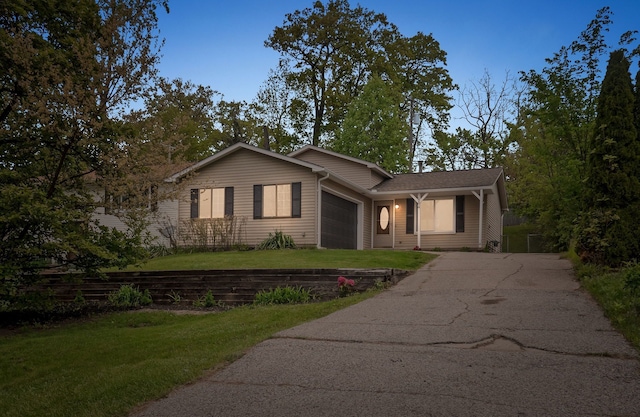 3884 Cass Elizabeth Rd, Waterford, MI 48328 - view of front facade featuring asphalt driveway, a garage, and a front lawn