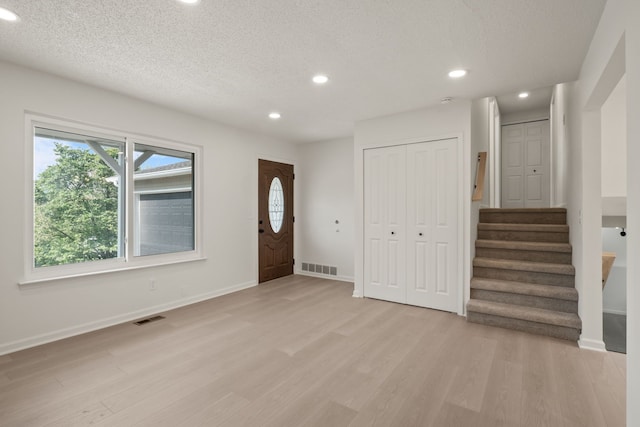 3884 Cass Elizabeth Rd, Waterford, MI 48328 - entryway with recessed lighting, light wood-style flooring, stairway, and a textured ceiling