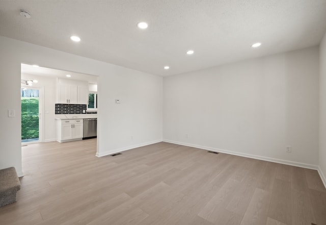 3884 Cass Elizabeth Rd, Waterford, MI 48328 - unfurnished living room with light wood-style floors and recessed lighting