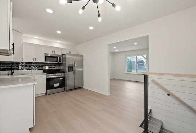 3884 Cass Elizabeth Rd, Waterford, MI 48328 - kitchen featuring appliances with stainless steel finishes, recessed lighting, backsplash, light wood-type flooring, and light stone countertops