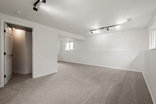 3884 Cass Elizabeth Rd, Waterford, MI 48328 - basement featuring track lighting, a textured ceiling, and carpet flooring