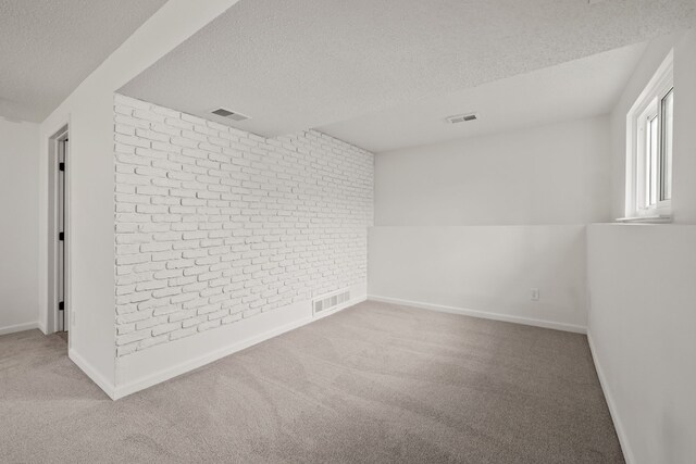 3884 Cass Elizabeth Rd, Waterford, MI 48328 - unfurnished room featuring a textured ceiling, brick wall, and carpet flooring